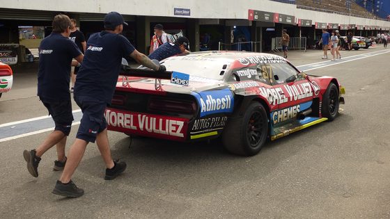 Crew working in the pit lane